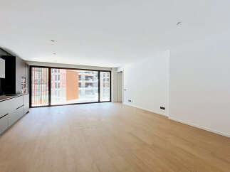 Experience modern living in this spacious, light-filled apartment featuring a sleek, integrated kitchen with ample cabinet space.