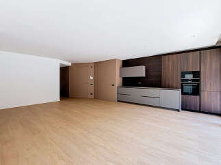 Experience modern living in this spacious, unfurnished apartment featuring a sleek, integrated kitchen with high-end appliances and ample cabinet space.