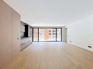 Discover modern living in this spacious, open-plan apartment featuring a sleek, integrated kitchen with ample cabinetry and a stunning floor-to-ceiling window that floods the living area with natural light.