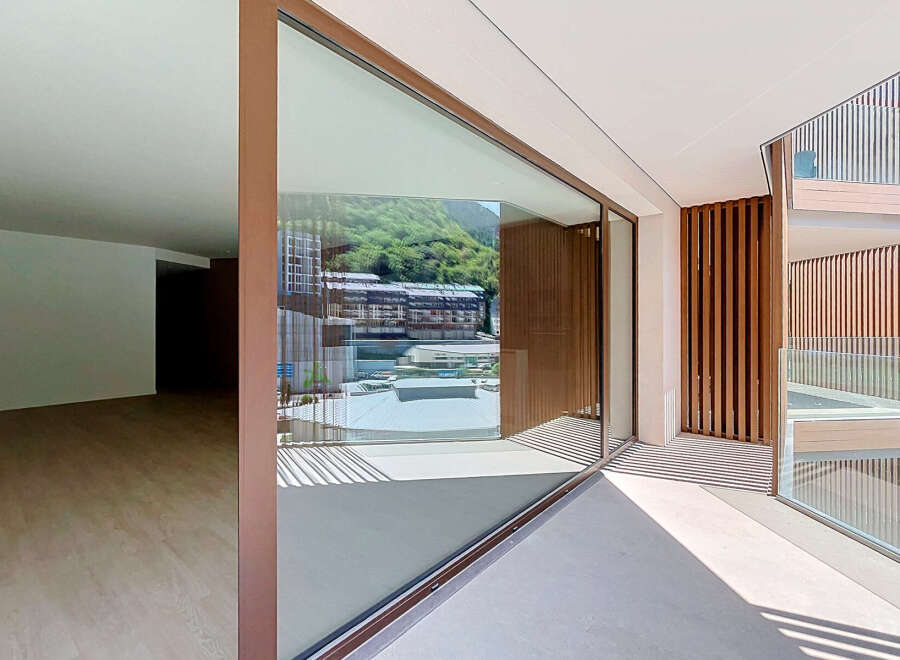 Experience modern living with expansive glass walls that seamlessly blend indoor and outdoor spaces, offering breathtaking views of the surrounding landscape.