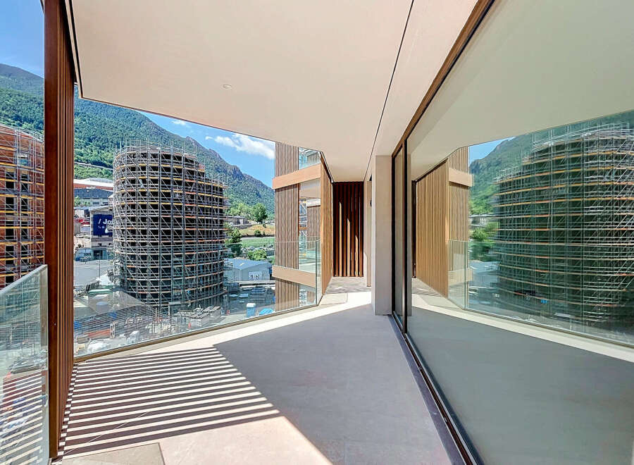 Experience modern living with this stunning balcony offering panoramic mountain views and sleek architectural design.