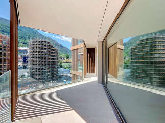 Experience modern living with this stunning balcony offering panoramic mountain views and sleek architectural design.