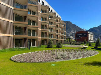Experience modern living in this stunning apartment complex, featuring a unique architectural design with wood-paneled facades and expansive balconies offering breathtaking mountain views.