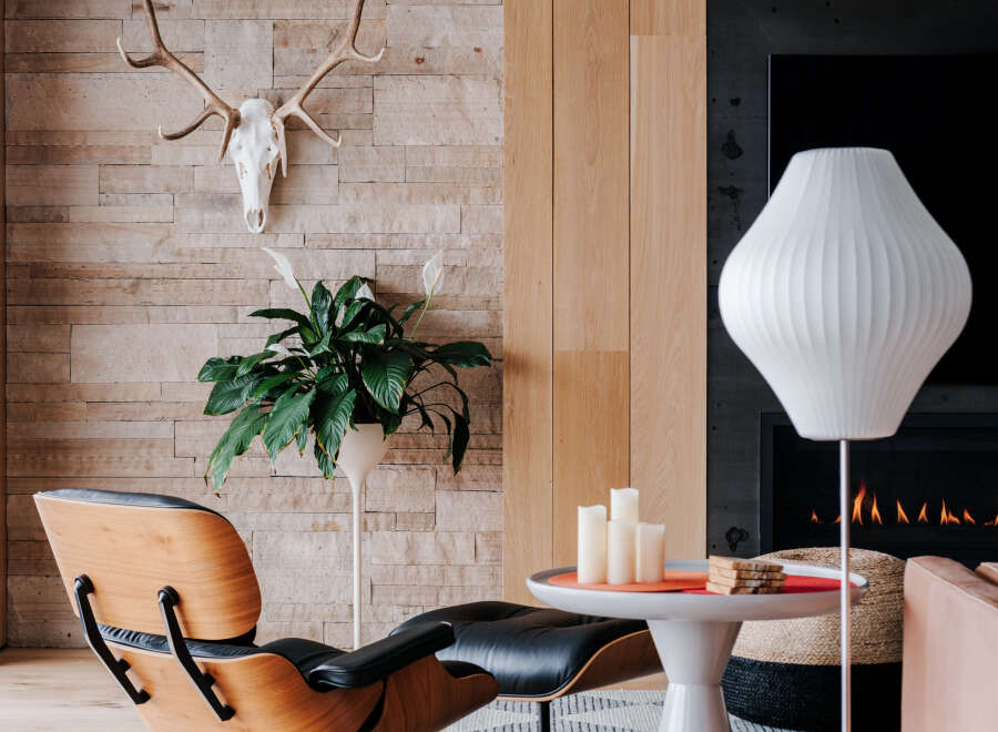 Experience modern living in this stylish room featuring a unique Eames lounge chair and ottoman, perfect for relaxation.