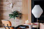 Experience modern living in this stylish room featuring a unique Eames lounge chair and ottoman, perfect for relaxation.