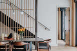 Experience modern living with this stunning dining area featuring a sleek stone-top table and comfortable wooden chairs.