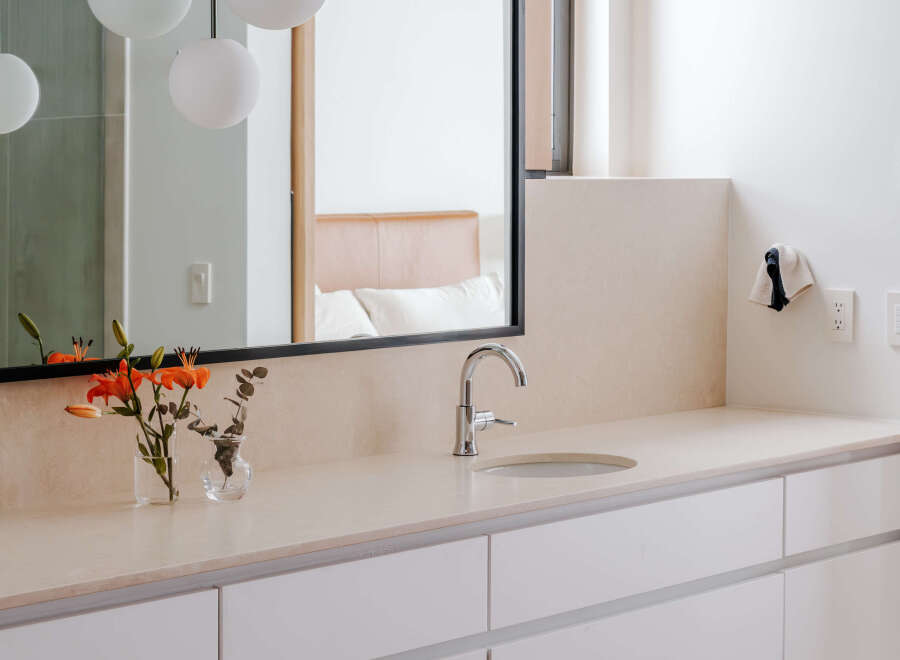 This modern bathroom features a sleek vanity with ample storage and a minimalist design.