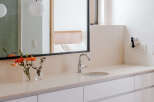 This modern bathroom features a sleek vanity with ample storage and a minimalist design.