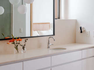 This modern bathroom features a sleek vanity with ample storage and a minimalist design.