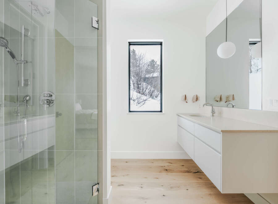 Experience modern luxury in this stunning bathroom featuring a sleek, floating vanity with a quartz countertop and a minimalist design.