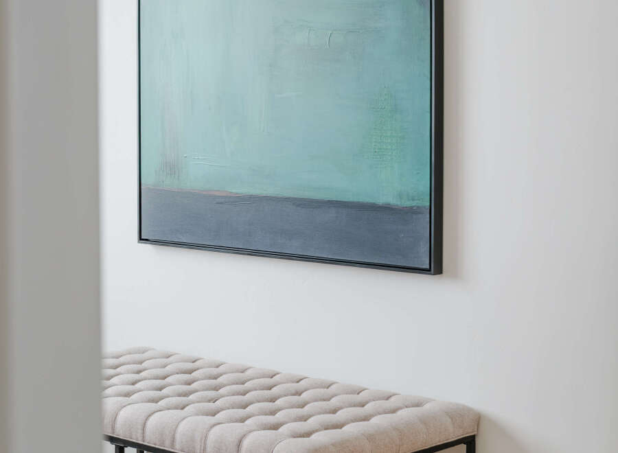 Enhance your entryway or living space with this elegant tufted bench, featuring a neutral upholstery and sleek black metal frame.