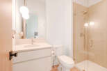 Experience modern luxury in this beautifully appointed bathroom, featuring a sleek vanity with a stone countertop and a stylish chrome faucet.