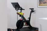 Elevate your fitness routine in this dedicated home gym space, featuring a top-of-the-line Peloton bike and adjustable dumbbells for a complete workout.