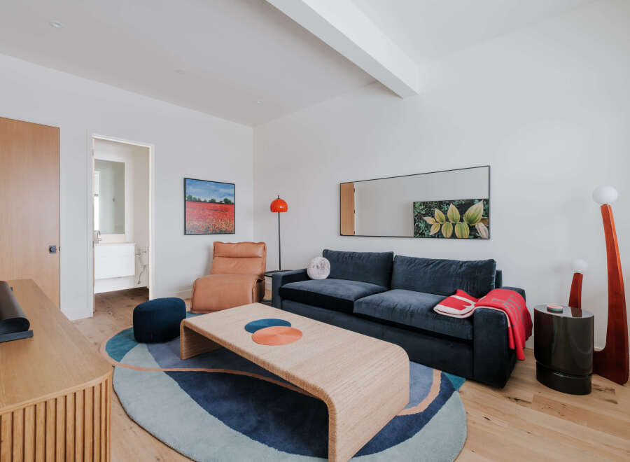 This stylish living room features a deep navy sofa complemented by a warm tan recliner and a unique woven coffee table.