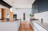 Experience modern luxury in this stunning kitchen, featuring sleek white cabinetry, a sophisticated marble island, and a professional-grade gas range.