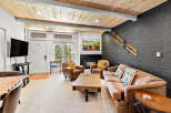 Experience cozy mountain living in this inviting living room, featuring a warm fireplace and comfortable leather seating.