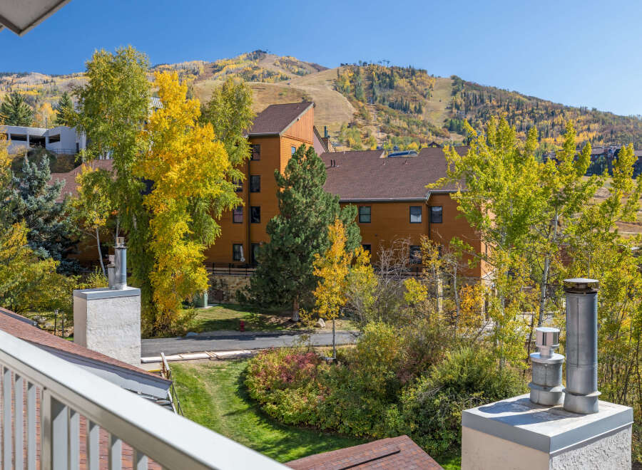 Experience the beauty of autumn from this property, offering stunning views of colorful fall foliage and ski slopes.