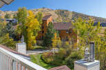 Experience the beauty of autumn from this property, offering stunning views of colorful fall foliage and ski slopes.