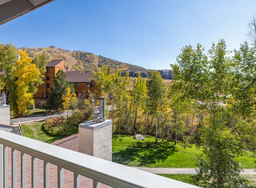 Experience the beauty of autumn from this stunning property, offering breathtaking views of colorful fall foliage and a picturesque mountain landscape.