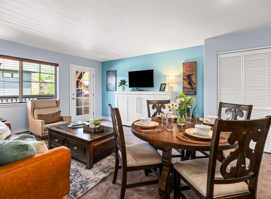 Experience comfortable living in this inviting space, featuring a cozy living area with plush seating and a stylish dining set perfect for meals.