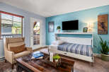 Experience mountain living in this charming room featuring a comfortable armchair and a convenient murphy bed.