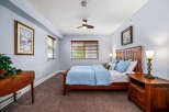 Experience comfort and style in this inviting bedroom, featuring a plush blue comforter on a sturdy wooden bed frame.