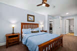 Experience comfort and style in this inviting bedroom, featuring a sturdy wooden bed frame and plush blue bedding.