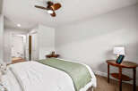 Experience comfort and style in this inviting bedroom, featuring a plush bed adorned with crisp white linens and a soothing green throw.
