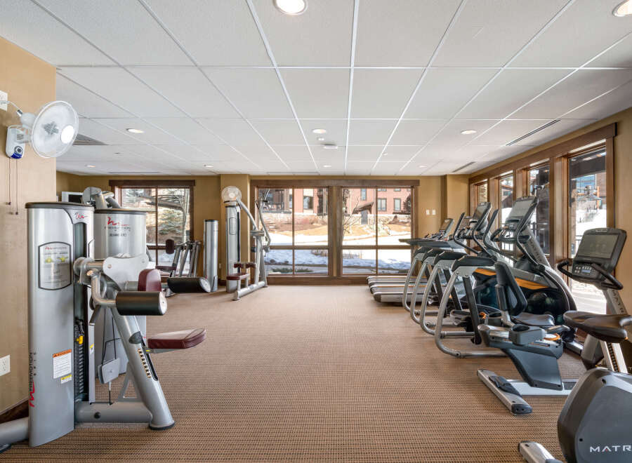 Stay active and energized in this well-equipped fitness center, featuring a variety of cardio machines like treadmills and ellipticals, alongside strength training equipment.