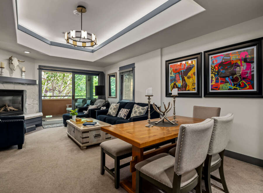 This inviting living and dining area features a cozy fireplace and comfortable seating, perfect for relaxing evenings.