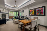 This inviting living and dining area features a cozy fireplace and comfortable seating, perfect for relaxing evenings.