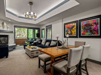 This inviting living and dining area features a cozy fireplace and comfortable seating, perfect for relaxing evenings.