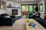 Cozy living room featuring a stone fireplace and comfortable navy blue seating.