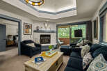 Step into this inviting living room, featuring a cozy stone fireplace and comfortable seating perfect for relaxation.