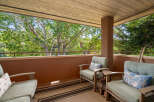 Enjoy the outdoors from this charming balcony, perfect for relaxing with a view of lush greenery.