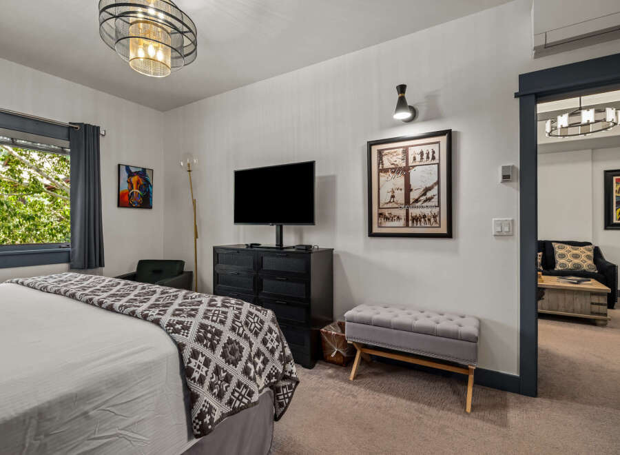 Experience comfort and style in this inviting bedroom, featuring a plush bed adorned with a decorative throw.