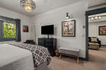 Experience comfort and style in this inviting bedroom, featuring a plush bed adorned with a decorative throw.