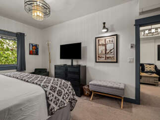 Experience comfort and style in this inviting bedroom, featuring a plush bed adorned with a decorative throw.