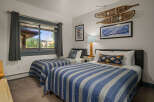 This charming bedroom features two comfortable twin beds, perfect for accommodating guests or family.