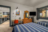 This inviting bedroom features two comfortable beds with blue and white striped comforters, perfect for a restful night's sleep.