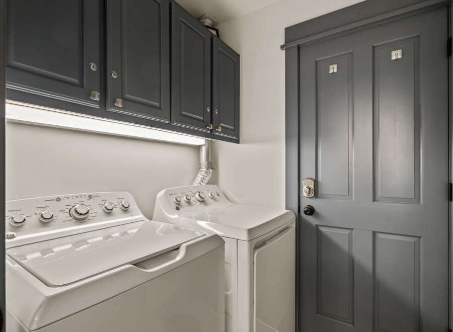 This laundry room features a stacked washer and dryer set, perfect for saving space.