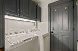 This laundry room features a stacked washer and dryer set, perfect for saving space.