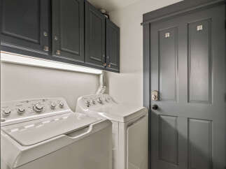 This laundry room features a stacked washer and dryer set, perfect for saving space.