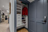 Discover ample storage solutions in this home, featuring a well-organized closet with shelving and drawers perfect for stowing away essentials.
