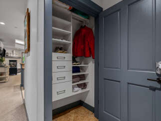 Discover ample storage solutions in this home, featuring a well-organized closet with shelving and drawers perfect for stowing away essentials.