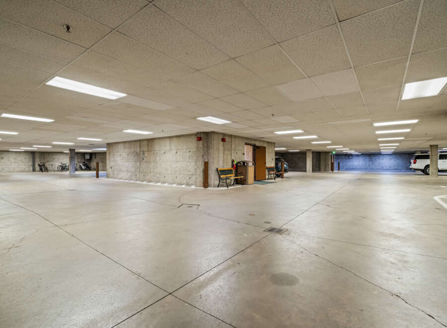 Discover secure and convenient parking in this spacious underground garage, featuring ample lighting and concrete construction for durability.