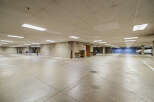 Discover secure and convenient parking in this spacious underground garage, featuring ample lighting and concrete construction for durability.