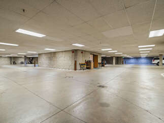 Discover secure and convenient parking in this spacious underground garage, featuring ample lighting and concrete construction for durability.