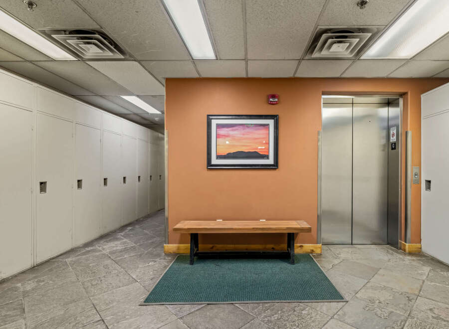 This image showcases a well-maintained hallway featuring rows of white lockers, perfect for storage or personal belongings.