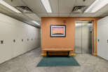 This image showcases a well-maintained hallway featuring rows of white lockers, perfect for storage or personal belongings.